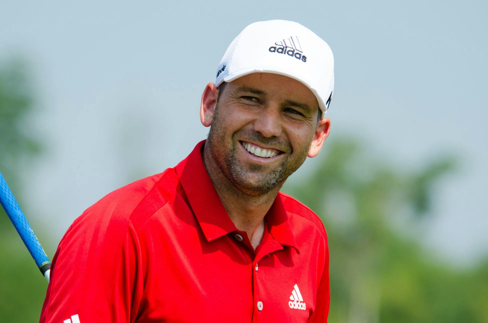 Sergio Garcia smiling on a golf course