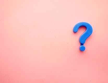 Blue question mark on a pink background